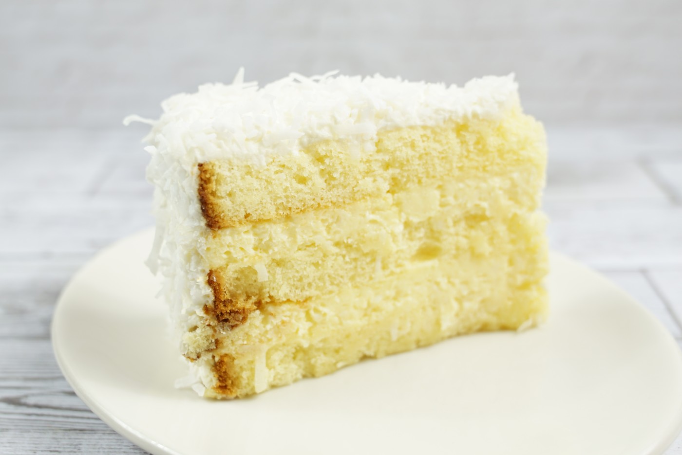 coconut cake slice savor the classic flavor of a traditional coconut cake slice at Mia's Bakery.