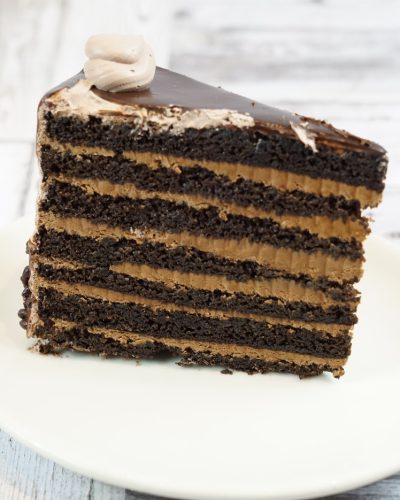 savor the classic flavor of a traditional chocolate layer cake slice at Mia's Bakery.
