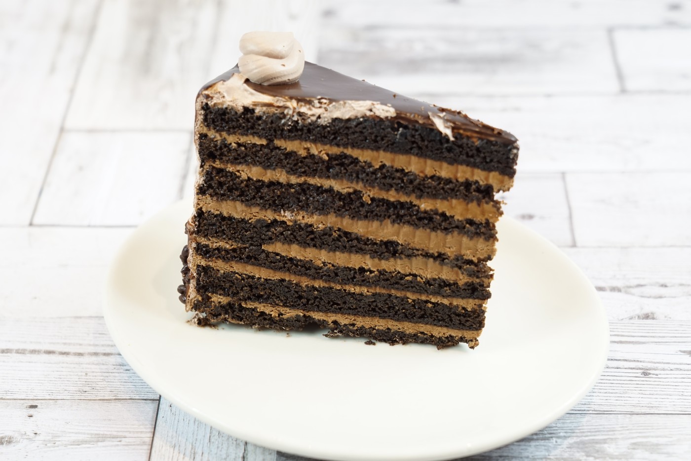 chocolate layer cake slice savor the classic flavor of a traditional chocolate layer cake slice at Mia's Bakery.