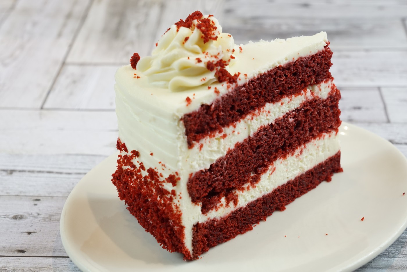 red velvet cake slice savor the classic flavor of a traditional red velvet cake slice at Mia's Bakery.