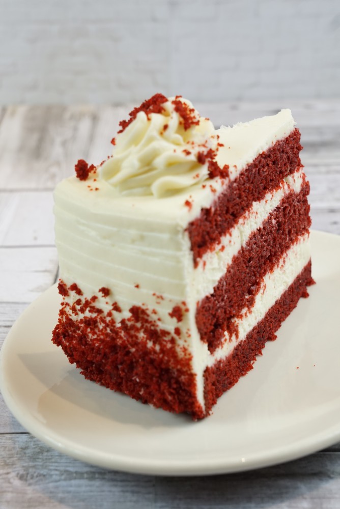 red velvet cake slice savor the classic flavor of a traditional red velvet cake slice at Mia's Bakery.
