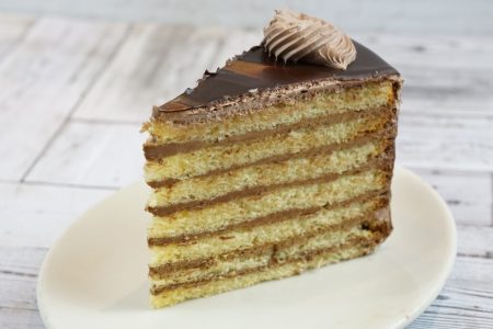 savor the classic flavor of our traditional 7 layer cake slice at Mia's Bakery.