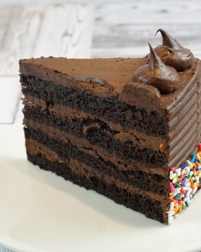 savor the classic flavor of a homemade chocolate fudge cake slice at Mia's Bakery.