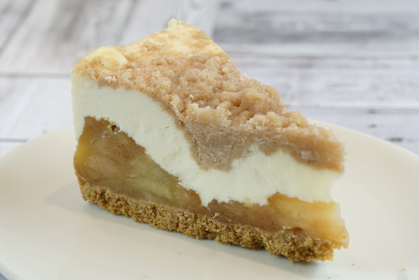apple cheesecake slice savor the classic flavor of a traditional New York style apple cheesecake slice at Mia's Bakery.