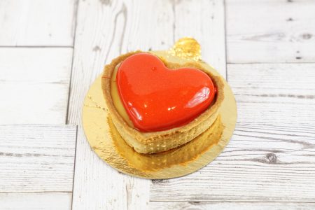 savor the classic flavor of a lemon raspberry tart at Mia's Bakery.