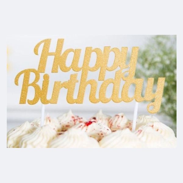 Gold Happy Birthday Cake Topper on White Frosted Cake - Premium Party Decoration Gold metallic "Happy Birthday" cake topper inserted into white frosted cake with decorative swirls, creating an elegant birthday party centerpiece against a soft background