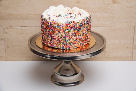 savor the classic flavor of a traditional rainbow cake at Mia's Bakery.
