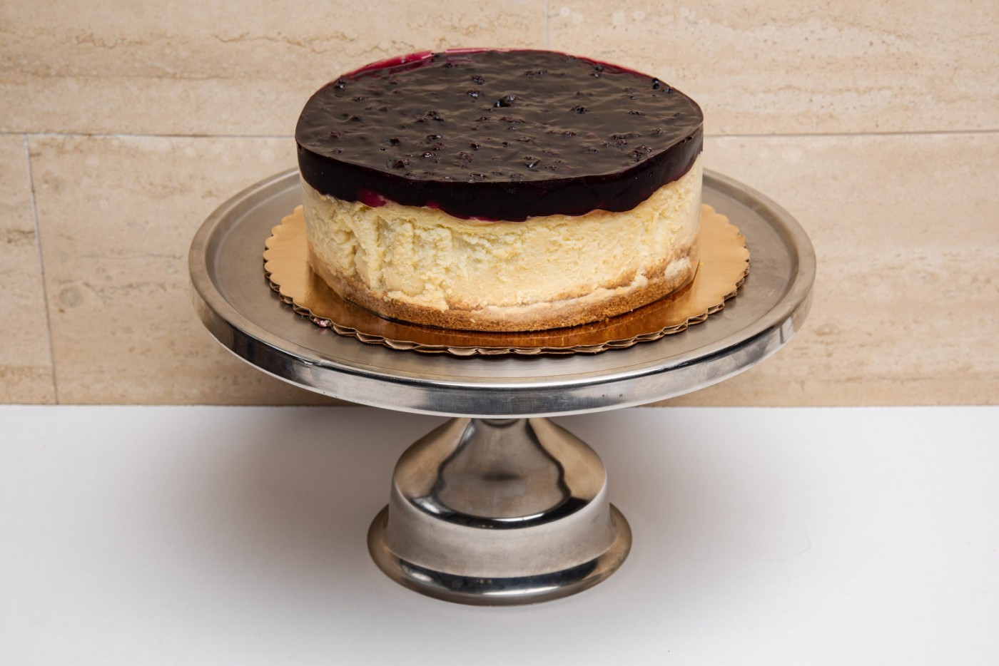 blueberry cheesecake savor the classic flavor of a New York style blueberry cheesecake at Mia's Bakery.