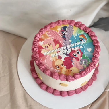 Round edible image cake featuring My Little Pony characters on a circular edible print topper with "Happy 4th Birthday Sofia" text. This custom photo cake from Mia's Bakery is decorated with pink rosette buttercream borders and white frosting sides. The cake showcases colorful ponies including Twilight Sparkle and friends on the edible image print, perfect for children's birthday celebrations.