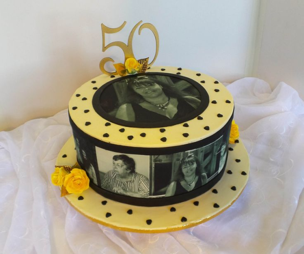 Round black and gold edible image cake featuring vintage photo film strip design with multiple black and white portraits circling the sides. This custom photo cake from Mia's Bakery showcases a central circular portrait on top, gold "50" cake topper, and black polka dot decorations on yellow borders. Perfect for 50th birthday celebrations and milestone anniversaries with personalized edible photo prints creating a nostalgic film reel effect.