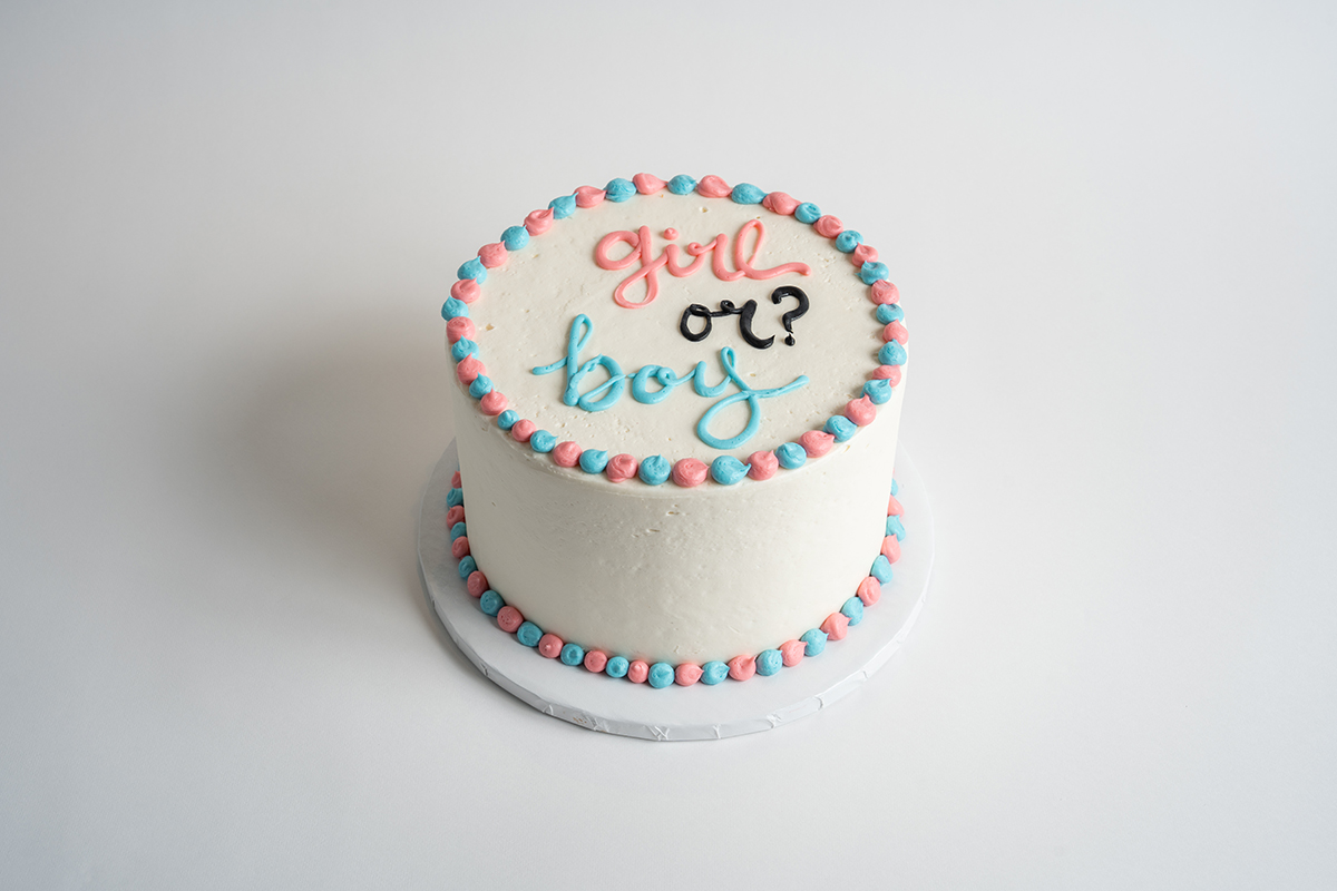 Simple Gender Reveal Cake – “Girl or Boy”? savor the classic flavor of a simple gender reveal at Mia's Bakery.