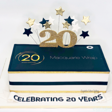 Square two-layer edible image cake featuring Macquarie Wrap branding with navy blue and gold design elements. This corporate photo cake from Mia's Bakery showcases "Celebrating 20 Years" text on the bottom white layer and the company logo on the navy blue top layer. Decorated with gold "20" numbers and star toppers, this custom photo cake uses edible image printing for professional corporate celebrations and milestone anniversaries.