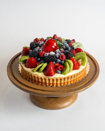 savor the classic flavor of a Fruit Tart at Mia's Bakery.