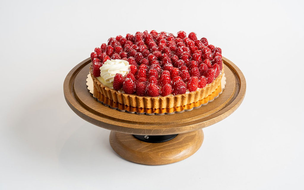 Fresh raspberry tart with cream filling, a stunning fruit-forward summer dessert idea for gatherings