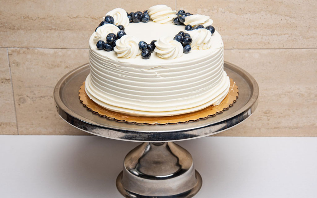 Lemon blueberry cake with buttercream and fresh berries, an elegant summer dessert idea for celebrations